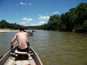 Man Canoeing Along Brazos River