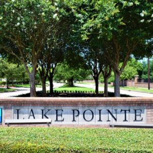 An image showcases the entrance of the Lake Pointe neighborhood in Sugar Land, TX.